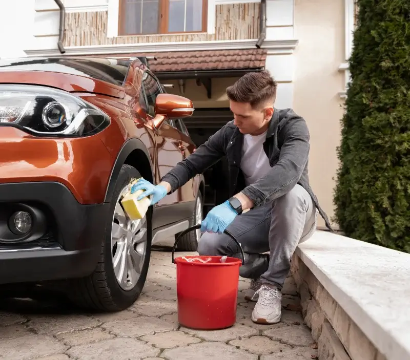 Lavage auto à domicile Auriac-sur-Vendinelle : professionnel intervenant sur un véhicule